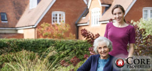 Picture of a woman and an elderly woman in front of house